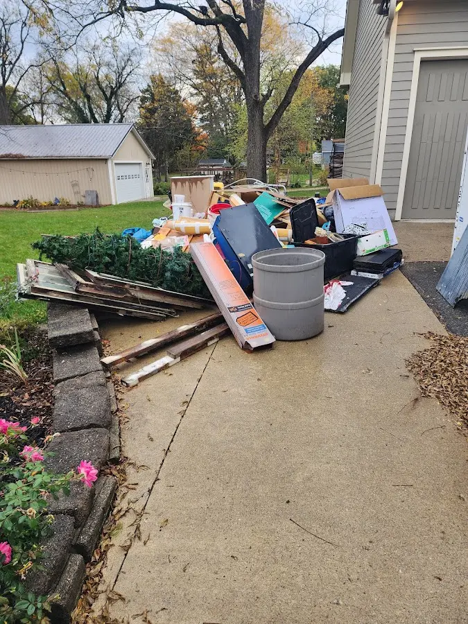Dumpster being loaded with debris for 12 Yard Dumpster Rental in Green Valley